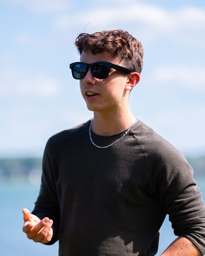Talking outdoors in Relay sunglasses.
